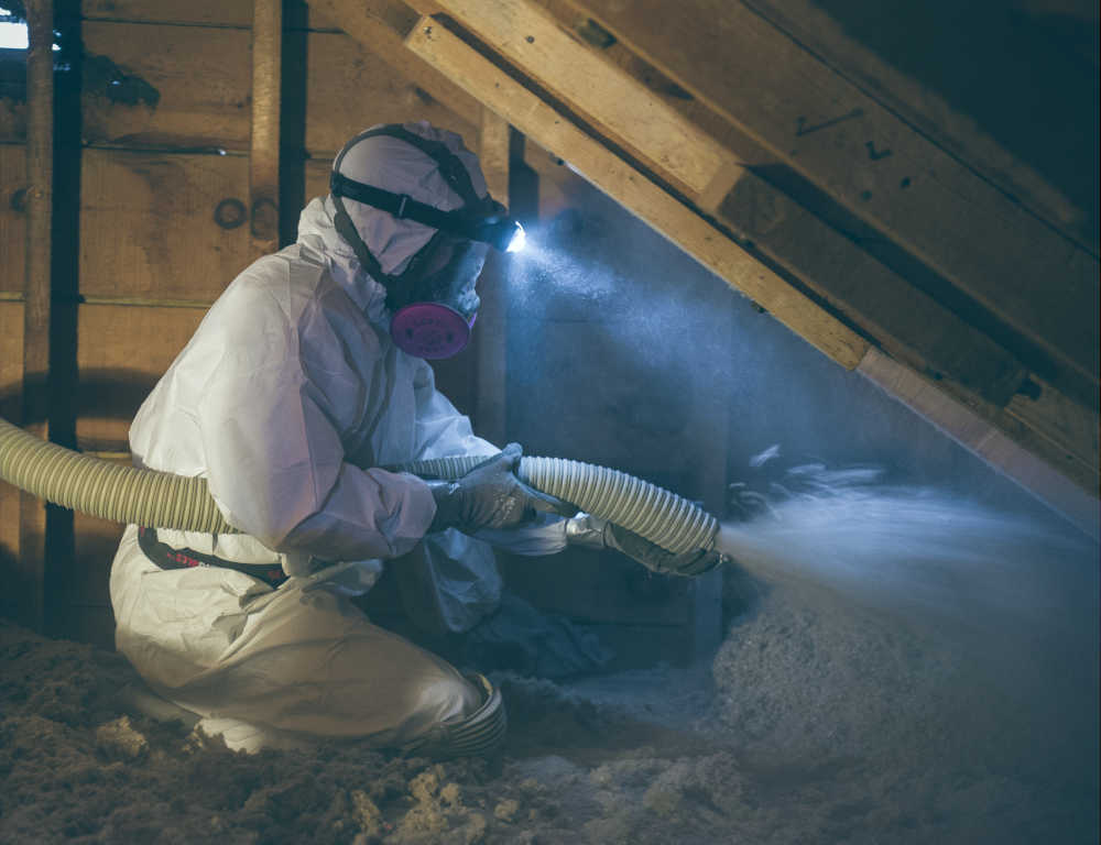 Person Blowing insulation in attic