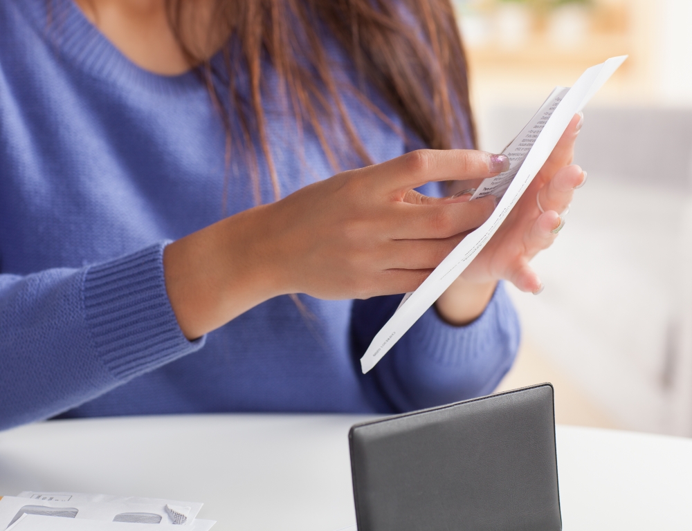 woman filling envelope