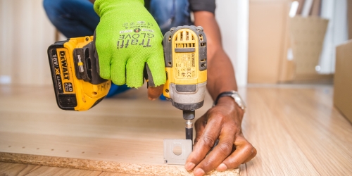 man drilling wood